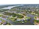 A scenic aerial view of waterfront homes with canals and boat docks in a lush, green community at 15490 Seafoam Cir, Port Charlotte, FL 33981