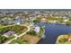 A waterfront community featuring custom homes with canals, boat docks, and lush landscaping at 15490 Seafoam Cir, Port Charlotte, FL 33981