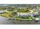Panoramic aerial perspective featuring a home with a pool, private dock, and beautifully landscaped grounds at 15490 Seafoam Cir, Port Charlotte, FL 33981