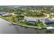 Waterfront home featuring a screened pool, boat dock, lush landscaping, and private backyard at 15490 Seafoam Cir, Port Charlotte, FL 33981