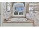 Close up of a soaking tub with view outside the plantation shutters at 15490 Seafoam Cir, Port Charlotte, FL 33981