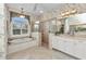 Bright bathroom with a large soaking tub, glass shower, and dual sink vanity at 15490 Seafoam Cir, Port Charlotte, FL 33981