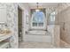 Bright bathroom with a large soaking tub and glass shower at 15490 Seafoam Cir, Port Charlotte, FL 33981