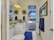 Bathroom with a vanity, a toilet and a door leading to an outdoor pool at 15490 Seafoam Cir, Port Charlotte, FL 33981