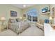 Bright bedroom showcases a decorative bed frame, a lounger, and a window for natural light at 15490 Seafoam Cir, Port Charlotte, FL 33981