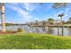 Boat lift on the water, surrounded by green lawn and landscaping at 15490 Seafoam Cir, Port Charlotte, FL 33981