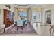 Formal dining room boasts a chandelier, decorative rug, and ample natural light at 15490 Seafoam Cir, Port Charlotte, FL 33981
