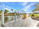 Inviting waterfront featuring a boat lift, dock, and comfortable seating offering serene water views at 15490 Seafoam Cir, Port Charlotte, FL 33981