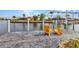 Waterfront view featuring a dock with comfortable seating and a boat lift for easy access to the water at 15490 Seafoam Cir, Port Charlotte, FL 33981