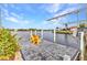 Picturesque waterfront featuring a dock with seating and boat lift for enjoying scenic water views at 15490 Seafoam Cir, Port Charlotte, FL 33981