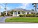 Charming, single-story home with a well-manicured lawn, tasteful landscaping, and a circular driveway at 15490 Seafoam Cir, Port Charlotte, FL 33981
