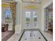 Grand foyer with decorative tile flooring, ornate front doors, and elegant architectural details at 15490 Seafoam Cir, Port Charlotte, FL 33981