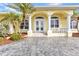 Elegant home featuring a beautifully landscaped front yard and a grand entryway with stately columns at 15490 Seafoam Cir, Port Charlotte, FL 33981