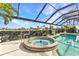 Relaxing hot tub adjacent to the pool, offering a spa-like experience at 15490 Seafoam Cir, Port Charlotte, FL 33981