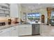 Well-equipped kitchen featuring white cabinetry, granite countertops, and stainless steel appliances at 15490 Seafoam Cir, Port Charlotte, FL 33981