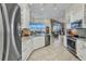 Modern kitchen with stainless steel appliances, granite countertops, and views of the outdoor area at 15490 Seafoam Cir, Port Charlotte, FL 33981