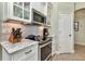 Kitchen features granite countertops, a smooth cooktop, and stainless steel microwave at 15490 Seafoam Cir, Port Charlotte, FL 33981