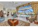 Spacious living room with large windows, tile flooring and pool view at 15490 Seafoam Cir, Port Charlotte, FL 33981