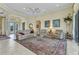 Inviting living room with tile floors, cozy seating, and an abundance of natural light at 15490 Seafoam Cir, Port Charlotte, FL 33981