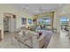 Open-concept living area with comfortable seating, tile floors, and sliding glass doors to the lanai at 15490 Seafoam Cir, Port Charlotte, FL 33981