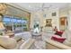 Bright living room with tile floors, neutral furniture, and views of the pool and lanai at 15490 Seafoam Cir, Port Charlotte, FL 33981