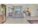Bright living room with tile floors, neutral furniture, and a view of the pool area at 15490 Seafoam Cir, Port Charlotte, FL 33981