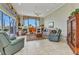 Living room featuring tile flooring, large windows, and comfortable seating at 15490 Seafoam Cir, Port Charlotte, FL 33981