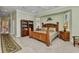Large bedroom featuring a wooden bed frame, soft carpet, and a built-in bookcase at 15490 Seafoam Cir, Port Charlotte, FL 33981