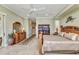Spacious bedroom with wood furniture, neutral colors, and carpet flooring at 15490 Seafoam Cir, Port Charlotte, FL 33981