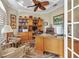Inviting home office with custom built-ins, desk, and ample natural light, perfect for working from home at 15490 Seafoam Cir, Port Charlotte, FL 33981