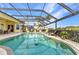 Inviting screened-in pool with patio seating, perfect for relaxation and enjoyment at 15490 Seafoam Cir, Port Charlotte, FL 33981