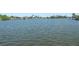 Scenic water view showcasing the tranquil waterfront property and lush landscaping at 15490 Seafoam Cir, Port Charlotte, FL 33981
