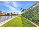 Scenic waterfront with manicured lawn and privacy hedges at 15490 Seafoam Cir, Port Charlotte, FL 33981