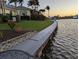 Lush landscaping meets the water's edge in this view from waterfront property at 15490 Seafoam Cir, Port Charlotte, FL 33981