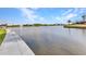 Scenic waterfront with a concrete walkway for leisurely strolls along the picturesque water's edge at 15490 Seafoam Cir, Port Charlotte, FL 33981