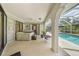 Covered back porch with a hot tub and access to the pool through sliding glass doors at 1556 Eagle St, Port Charlotte, FL 33952