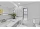 Bathroom featuring double sinks with white countertops, a large mirror, and a window for natural light at 1556 Eagle St, Port Charlotte, FL 33952