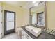 Bathroom with a modern vessel sink, decorative tile backsplash, and access to the outdoor patio at 1556 Eagle St, Port Charlotte, FL 33952