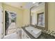 Bathroom featuring a vessel sink, mosaic tiles and an open door to the outdoor living space at 1556 Eagle St, Port Charlotte, FL 33952