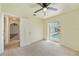 Bedroom featuring neutral carpet, a ceiling fan, and sliding door access to the pool at 1556 Eagle St, Port Charlotte, FL 33952