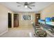 Carpeted bedroom featuring a desk with monitors, a ceiling fan, and built-in shelving at 1556 Eagle St, Port Charlotte, FL 33952