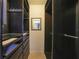 Spacious walk-in closet with custom shelving, drawers, hanging rods, and a decorative mirror at 1556 Eagle St, Port Charlotte, FL 33952
