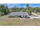 Charming single-story home with a well-manicured lawn and tasteful landscaping around the front of the house at 1556 Eagle St, Port Charlotte, FL 33952
