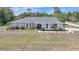 Charming single-story home with well-maintained landscaping and a lush green lawn at 1556 Eagle St, Port Charlotte, FL 33952