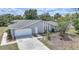Stylish single-story home with a wide driveway and well-manicured front yard at 1556 Eagle St, Port Charlotte, FL 33952