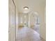 Inviting foyer with neutral tile flooring and an arched entryway to the living area at 1556 Eagle St, Port Charlotte, FL 33952