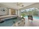 Close-up of a luxurious hot tub, adjacent to the screened-in pool area with tropical foliage views at 1556 Eagle St, Port Charlotte, FL 33952