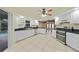 Well-lit kitchen featuring white cabinetry, tile floors, stainless appliances, and a view of the pool at 1556 Eagle St, Port Charlotte, FL 33952