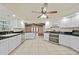 Bright kitchen with white cabinets, stainless steel appliances, tile floors, and adjacent living space at 1556 Eagle St, Port Charlotte, FL 33952