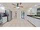 Spacious kitchen with stainless steel appliances, tiled floors, and black countertops for a modern aesthetic at 1556 Eagle St, Port Charlotte, FL 33952